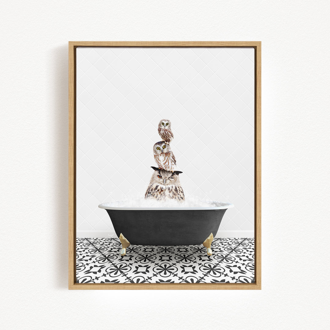 A framed image depicting three owls sitting on a black bathtub filled with water, with a black and white patterned tile floor beneath.