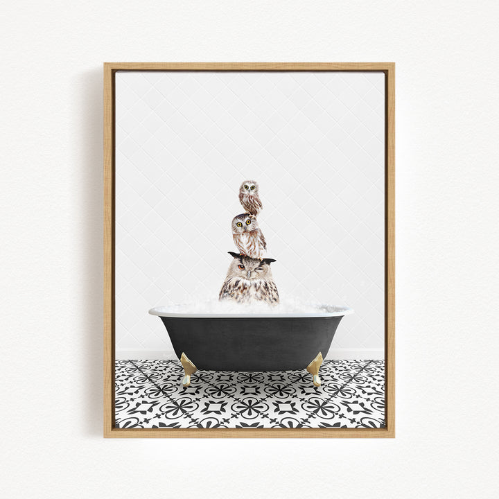 A framed image depicting three owls sitting on a black bathtub filled with water, with a black and white patterned tile floor beneath.