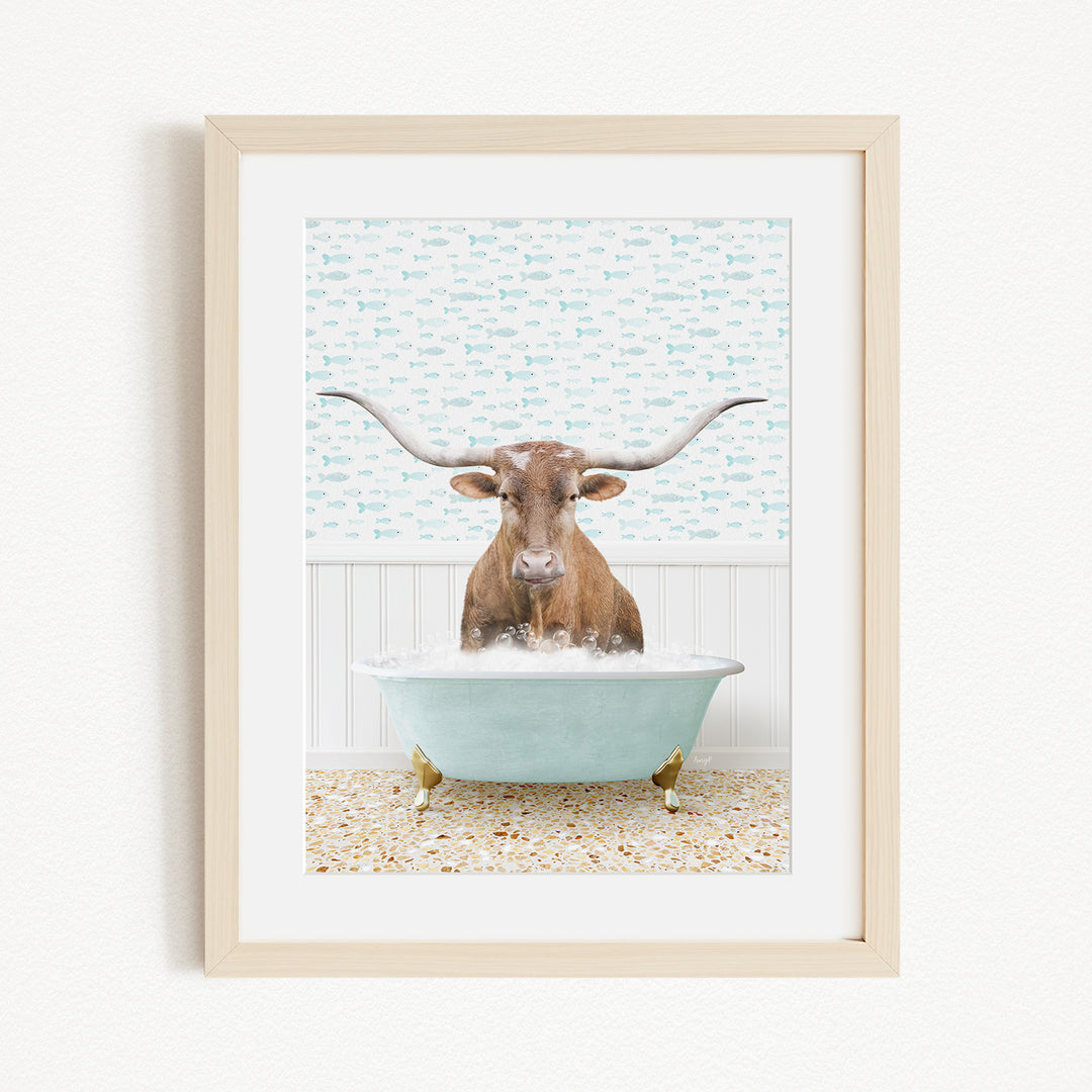 A brown cow with large horns is sitting in a light blue bathtub filled with bubbles, creating a whimsical and playful scene.