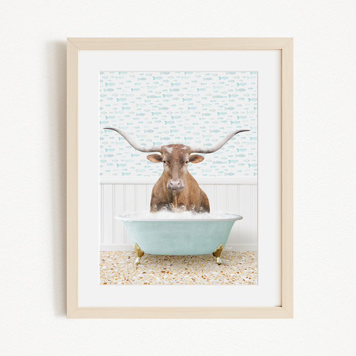 A brown cow with large horns is sitting in a light blue bathtub filled with bubbles, creating a whimsical and playful scene.