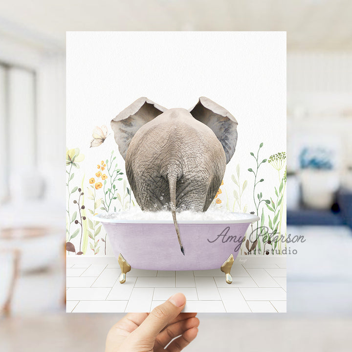 a person holding up a card with an elephant in a bathtub