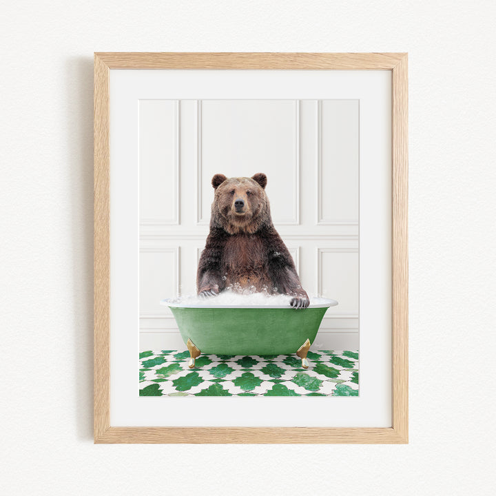 A brown bear sitting in a green bathtub filled with water, surrounded by a green and white patterned rug.