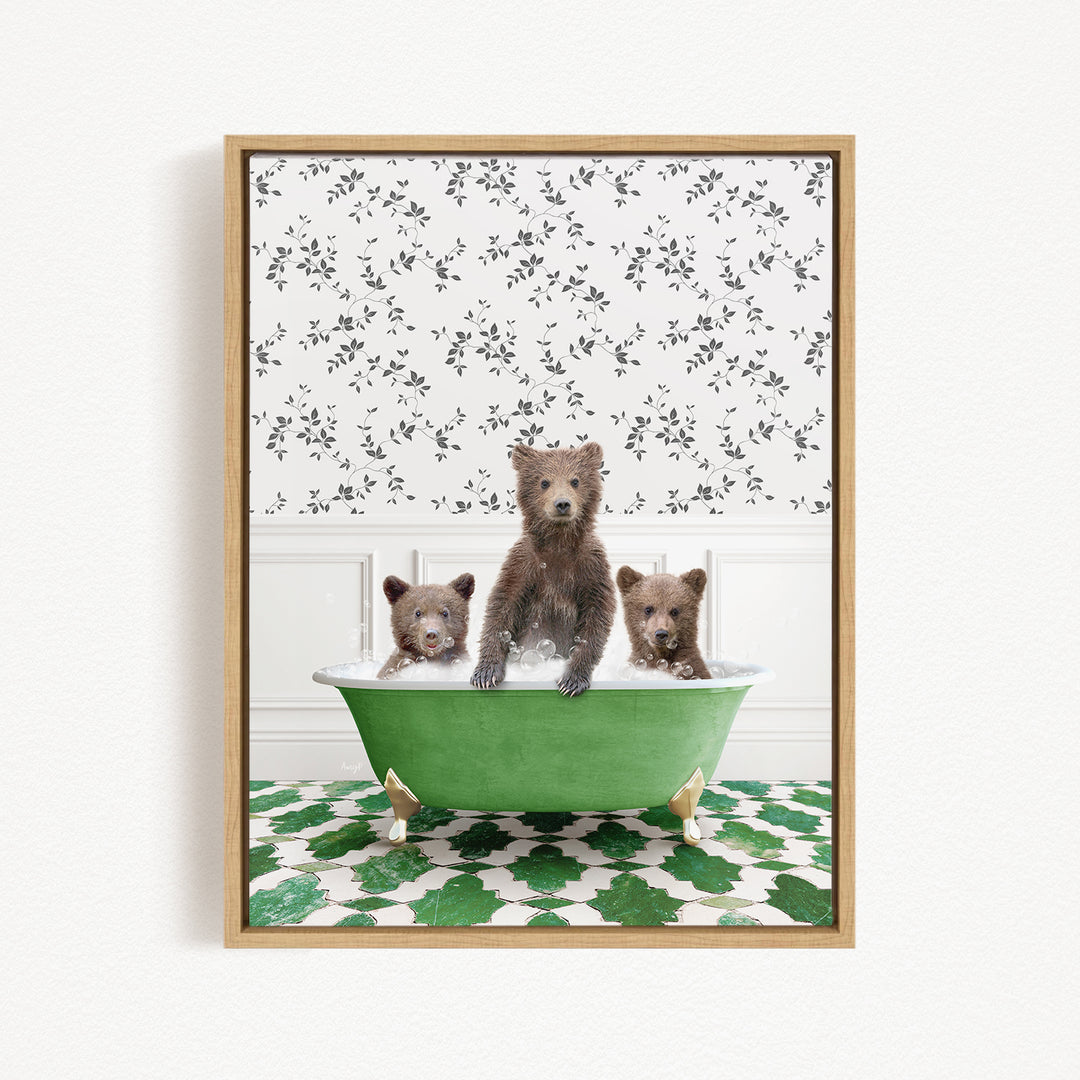 A framed image depicting three bears sitting in a green bathtub, with a patterned wall behind them.