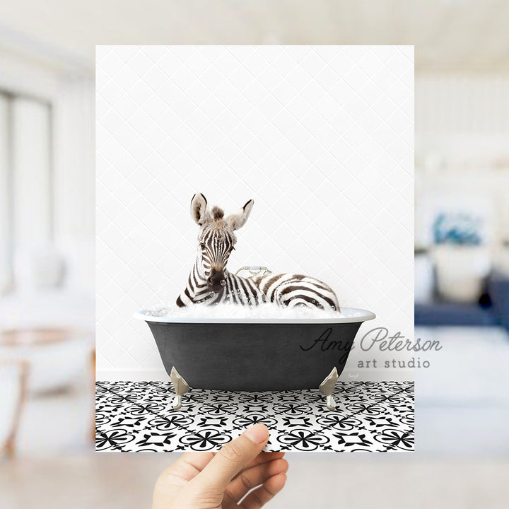 a person holding up a picture of a zebra in a bathtub