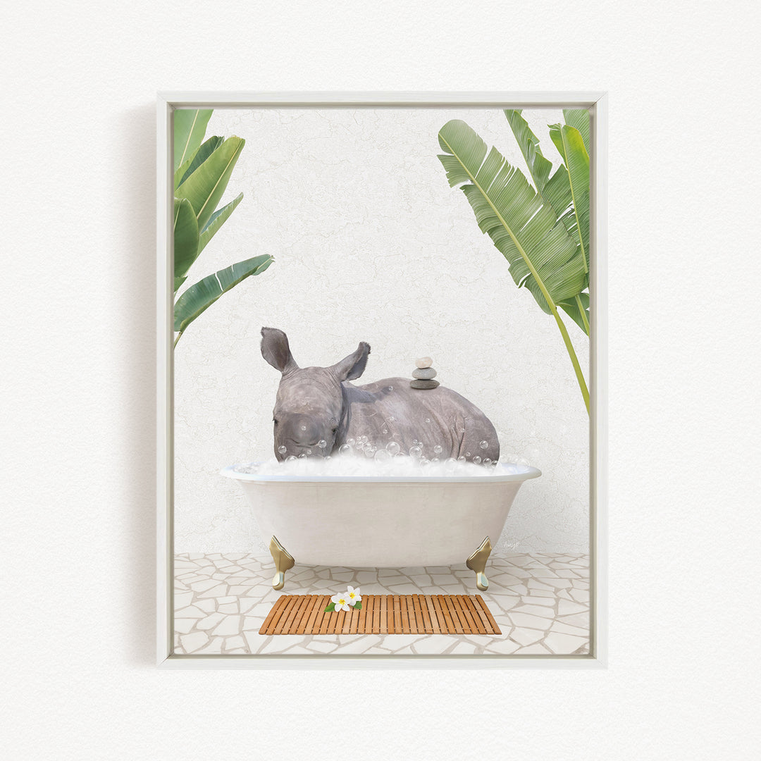 A rhinoceros is sitting in a bathtub filled with water, surrounded by tropical plants and a wooden mat on the floor.