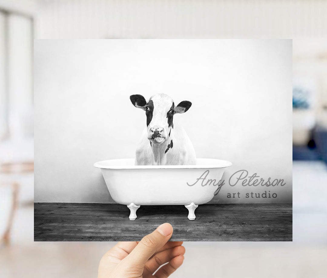 a black and white photo of a cow in a bathtub