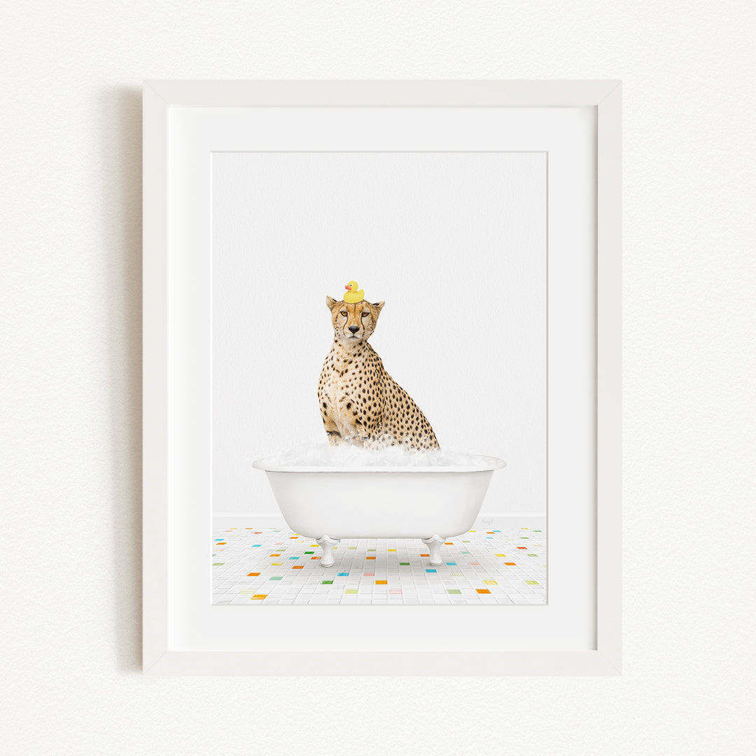 A cheetah wearing a yellow crown is sitting in a white bathtub filled with bubbles, surrounded by a colorful tiled floor.