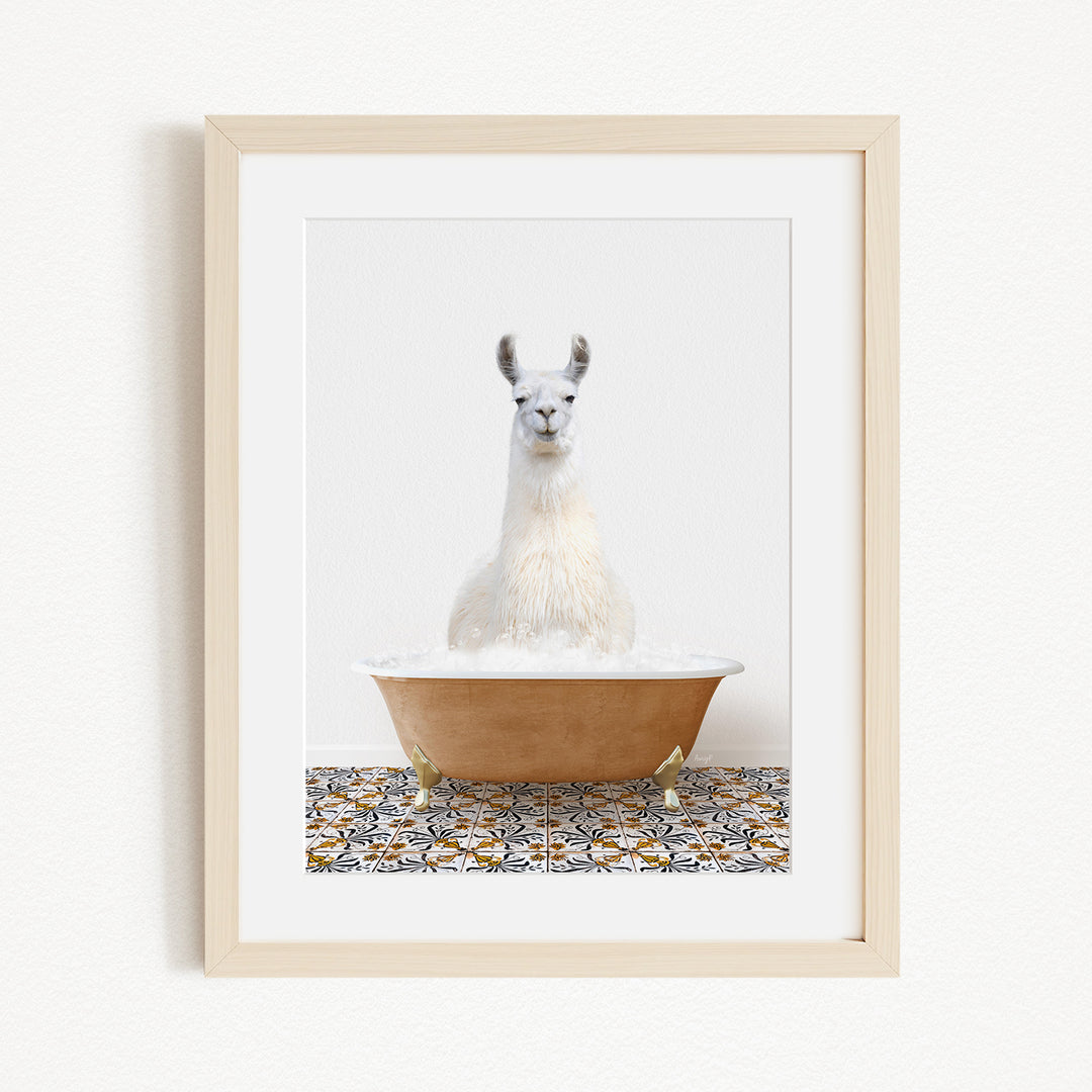 A white llama sitting in a brown bathtub filled with bubbles, with a patterned tile floor in the background.