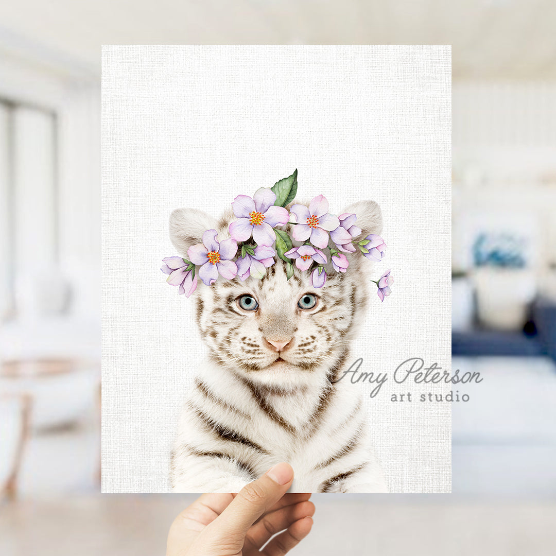 a hand holding a card with a picture of a white tiger wearing a flower crown