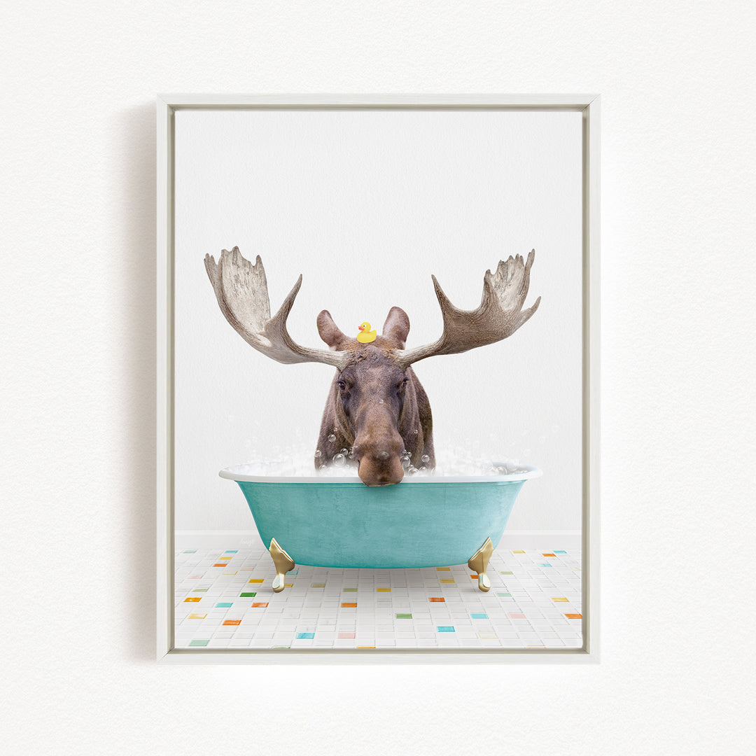 A moose with large antlers is sitting in a blue bathtub, surrounded by colorful tiles on the floor.