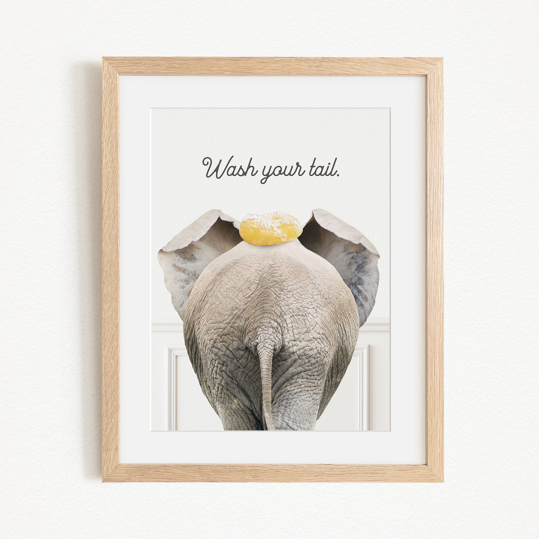 an elephant with a yellow object on its head, accompanied by the text "Wash your tail."
