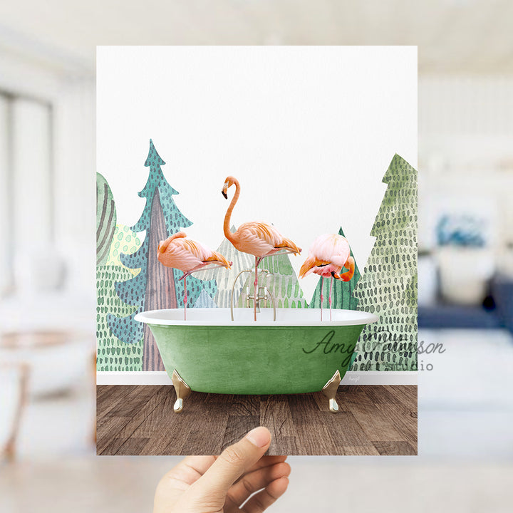 a person holding up a card with flamingos in a bathtub