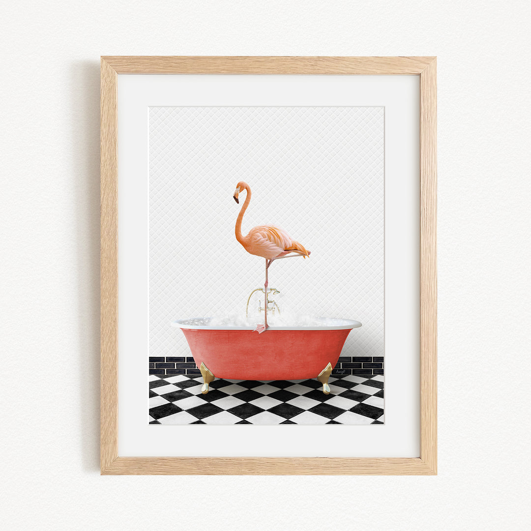 A framed image depicting a pink flamingo standing on a red bathtub with a black and white checkered floor.