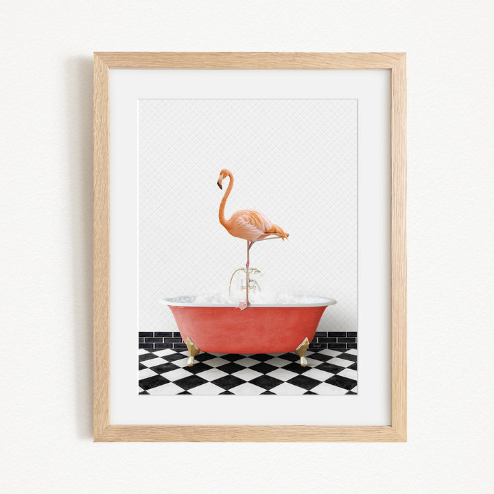 A framed image depicting a pink flamingo standing on a red bathtub with a black and white checkered floor.