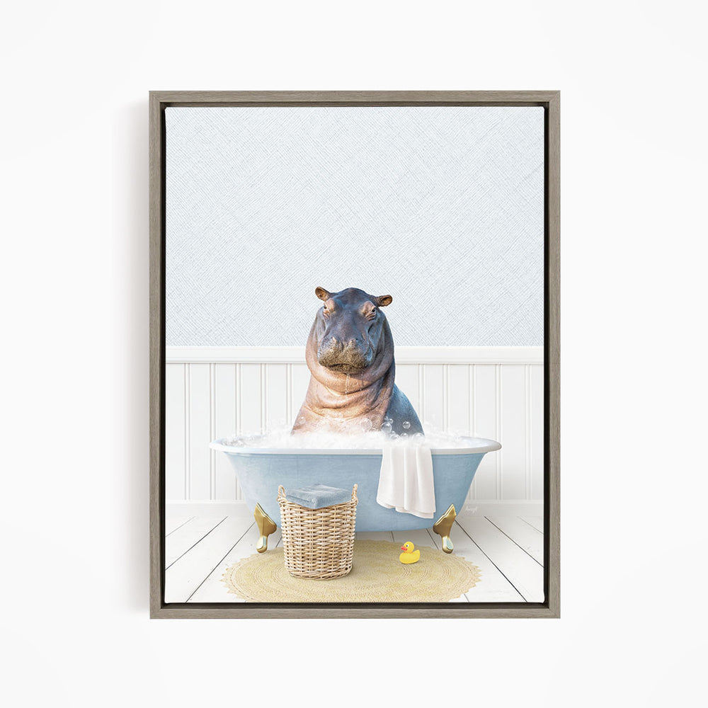 A hippopotamus sitting in a bathtub filled with water, surrounded by a basket of toys and a yellow rubber duck.