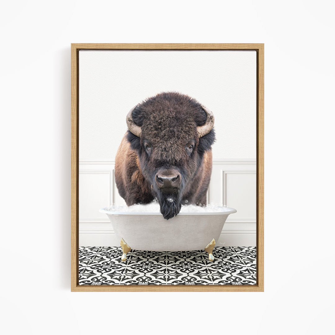 A buffalo with large horns is standing in a white bathtub filled with water, creating a humorous and unexpected scene.