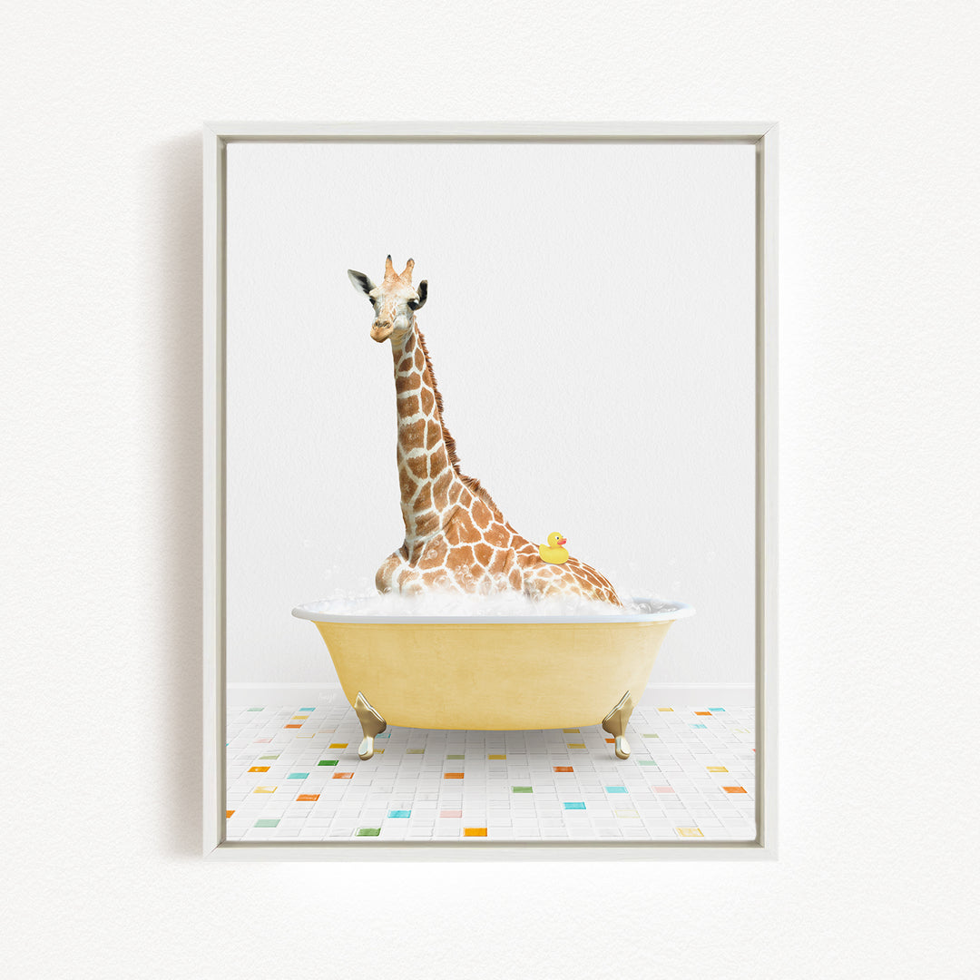 A giraffe is sitting in a yellow bathtub filled with bubbles, with a yellow rubber duck floating on the water.