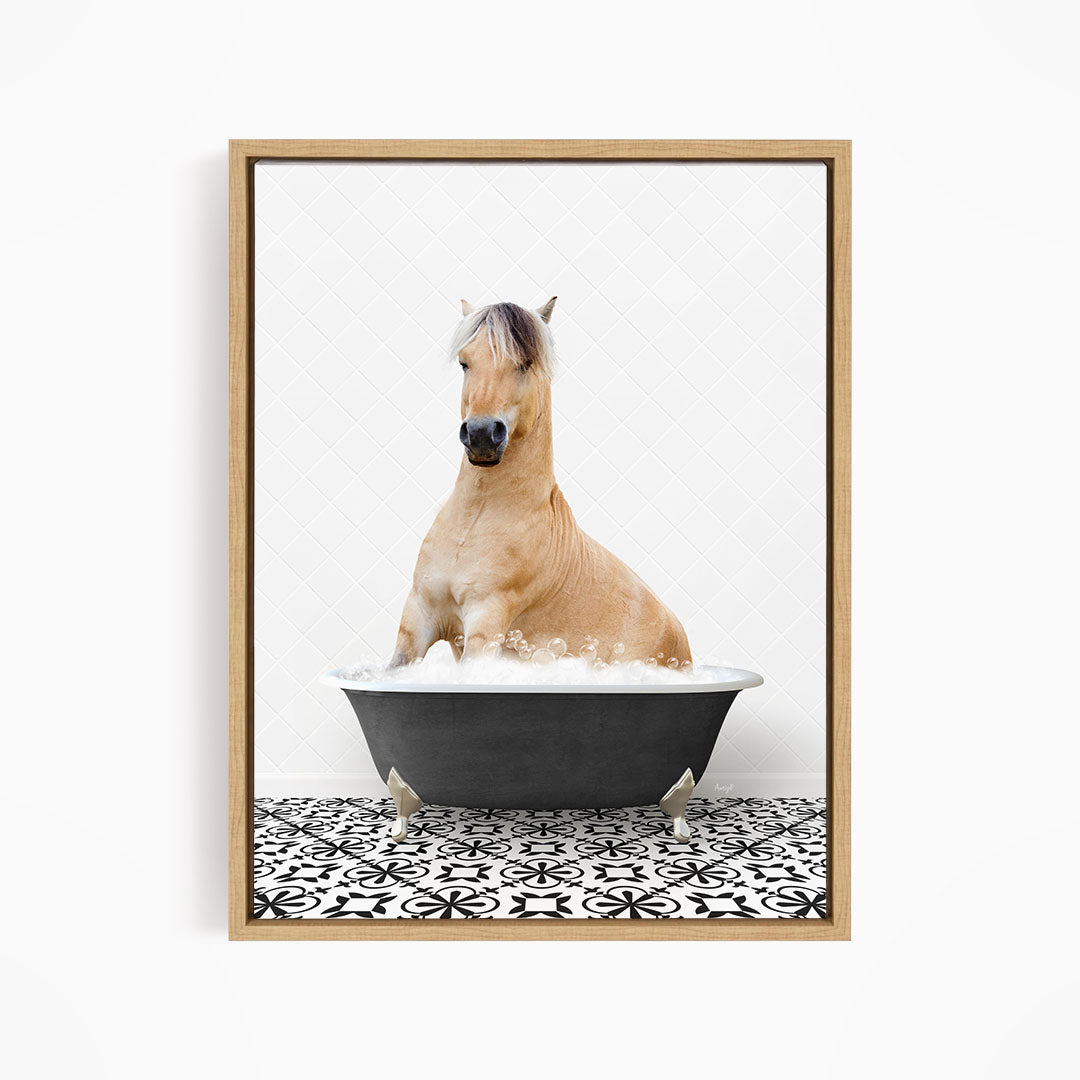 A light brown horse is sitting in a black bathtub filled with water, surrounded by a black and white patterned floor.