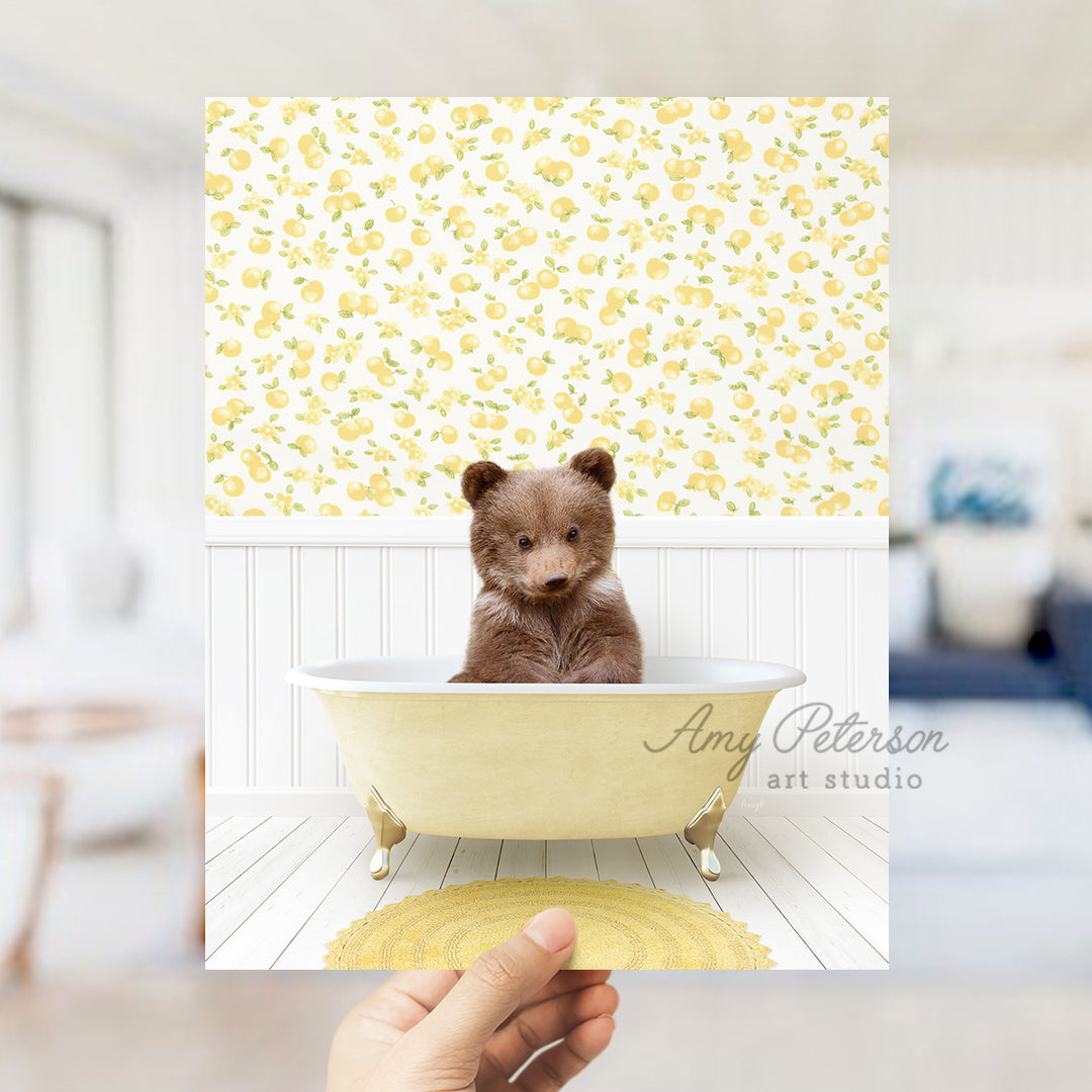 a person holding up a picture of a teddy bear in a bathtub