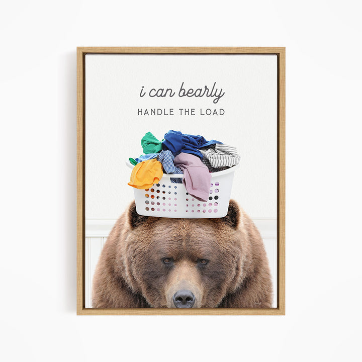 A brown bear sits on top of a laundry basket filled with clothes, with the text "I can bearly handle the load" written above the bear.