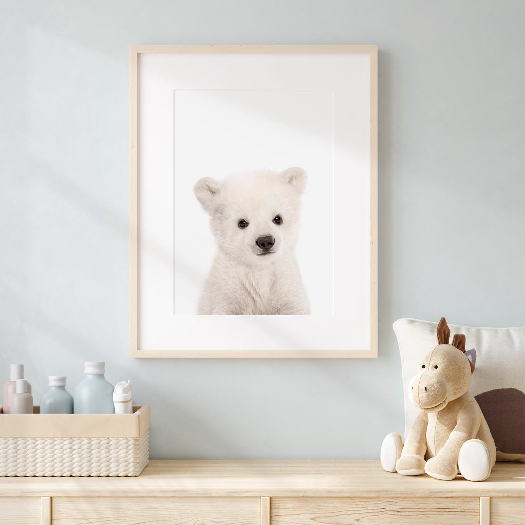 a picture of a polar bear in a frame on a dresser