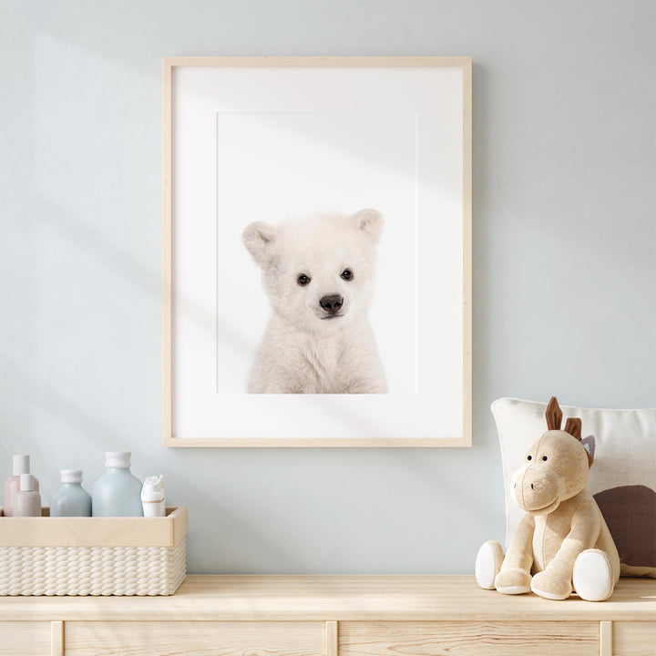 a picture of a polar bear in a frame on a dresser