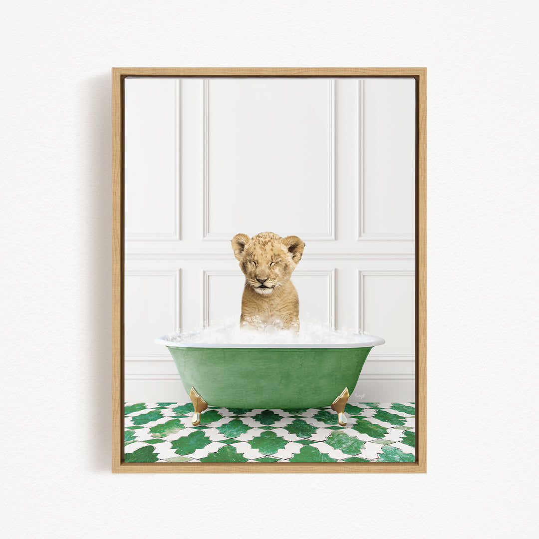 A young lion cub sitting in a green bathtub filled with water, with a patterned green and white floor beneath it.