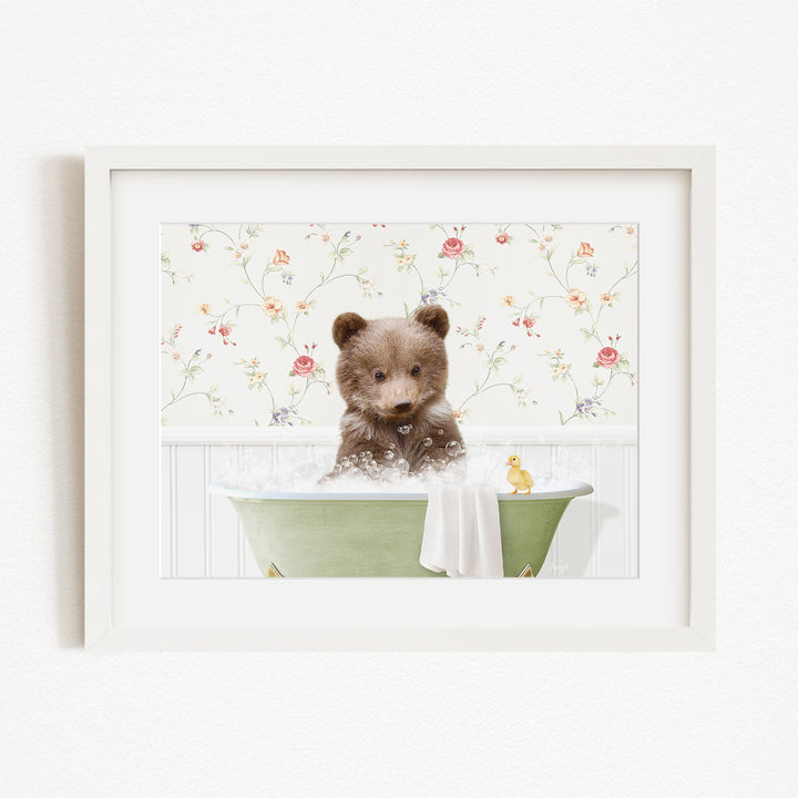A cute brown bear sitting in a green bathtub filled with bubbles, surrounded by a floral wallpaper.