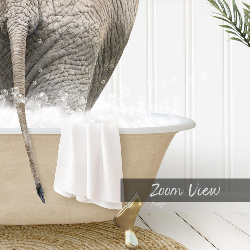 A close-up of an elephant's trunk in a bathtub filled with bubbles, with a towel and gold object nearby.