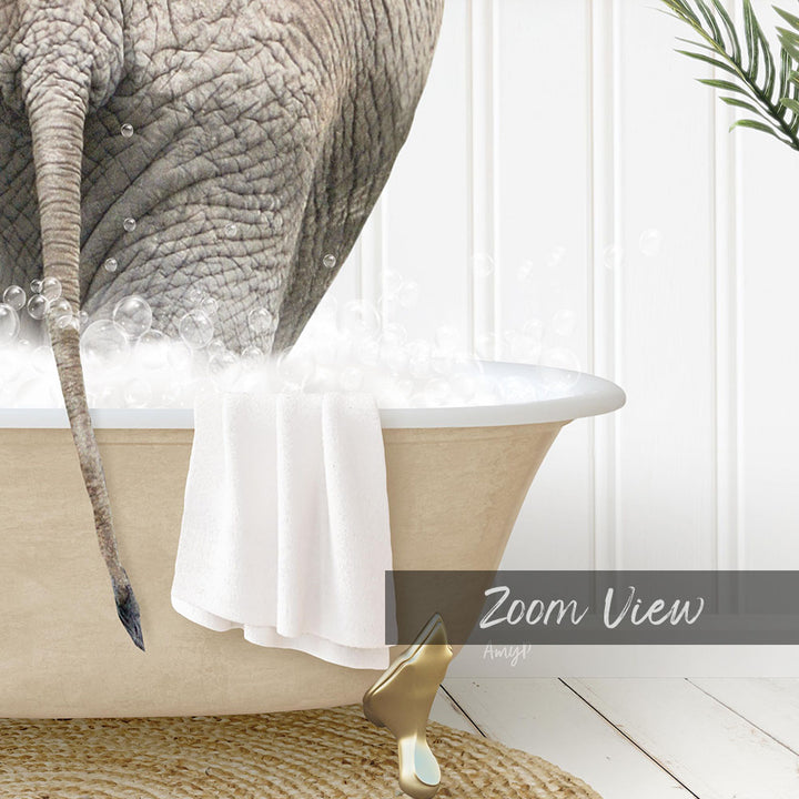 A close-up of an elephant's trunk in a bathtub filled with bubbles, with a towel and gold object nearby.