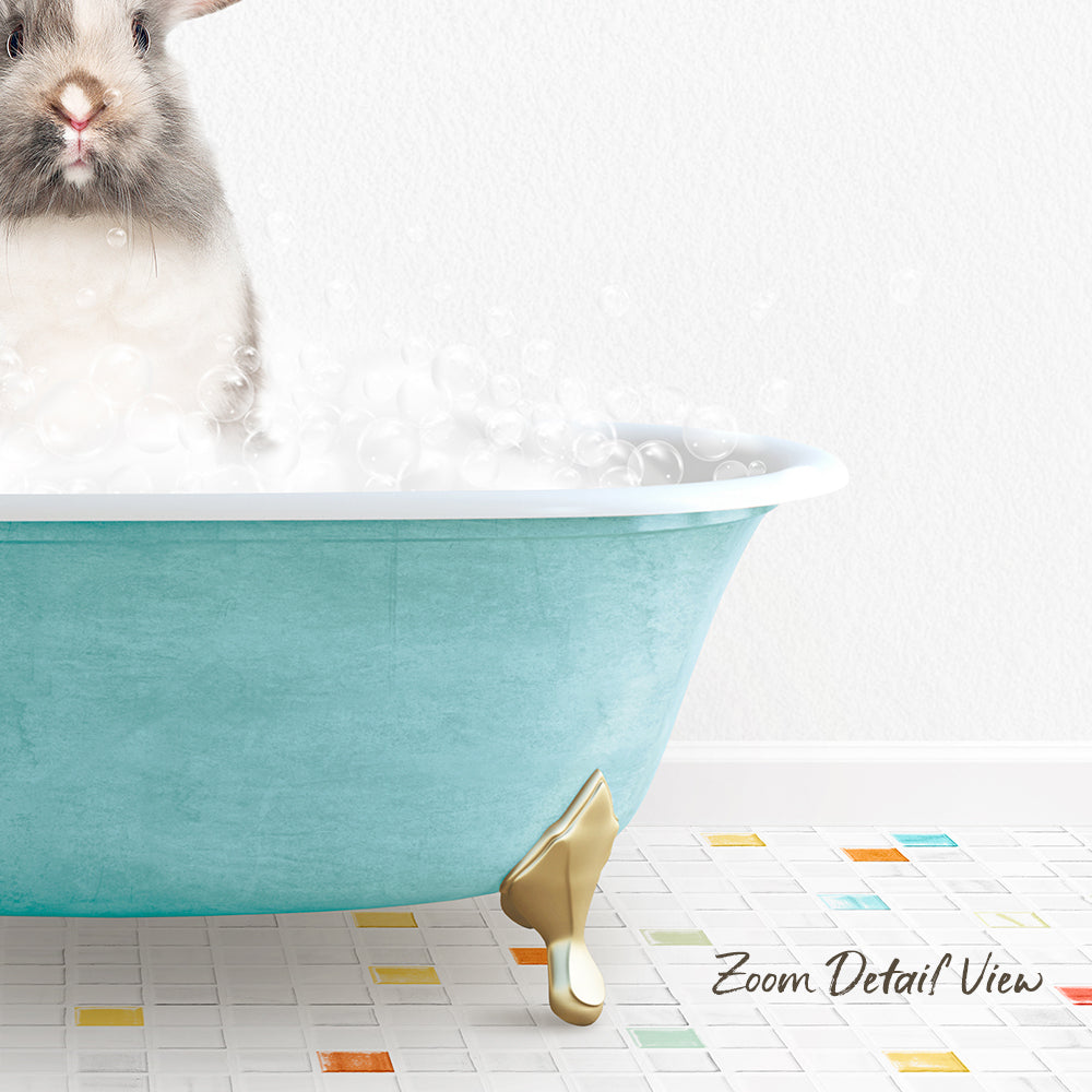 A small gray and white rabbit is sitting in a blue bathtub filled with bubbles, with a colorful tiled floor in the foreground.
