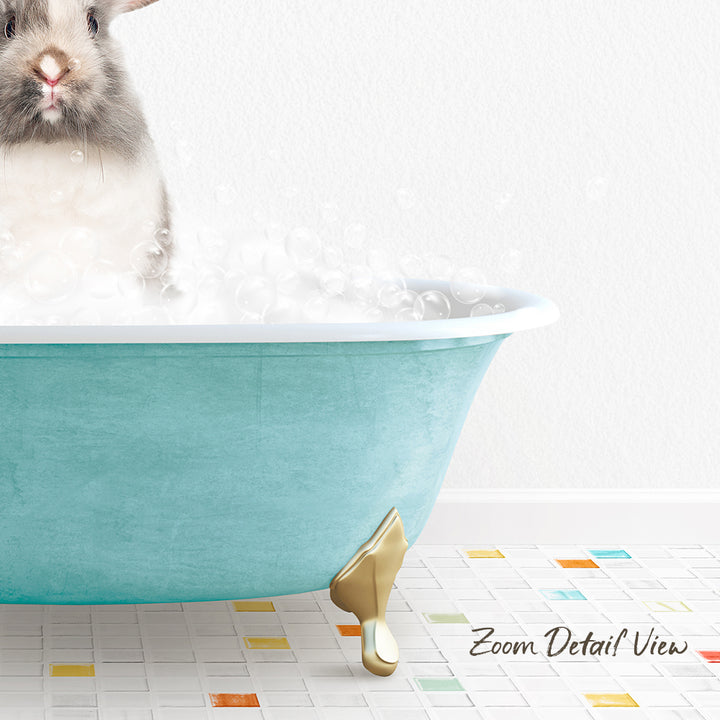 A small gray and white rabbit is sitting in a blue bathtub filled with bubbles, with a colorful tiled floor in the foreground.