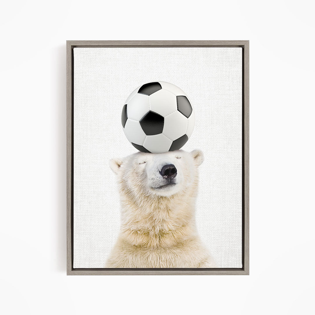 A polar bear balancing a soccer ball on its head.