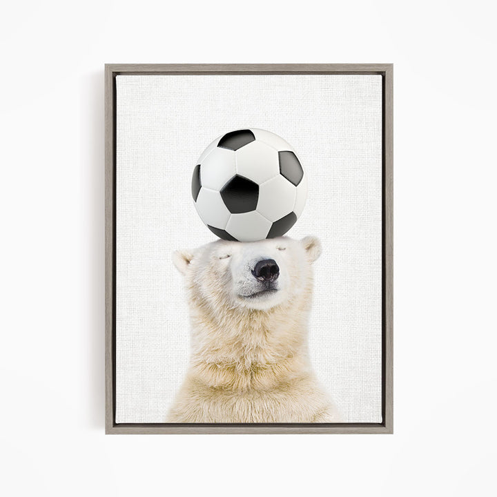 A polar bear balancing a soccer ball on its head.