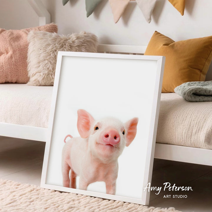 A framed photo of a cute, pink pig is displayed in a cozy living room setting.