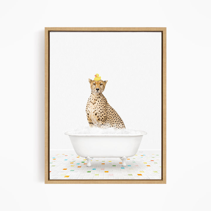 A cheetah sitting in a white bathtub filled with bubbles, wearing a yellow rubber duck on its head.