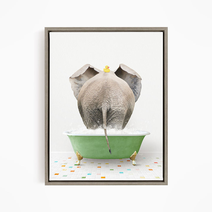 An elephant is taking a bath in a green tub, with a yellow rubber duck floating on its head.