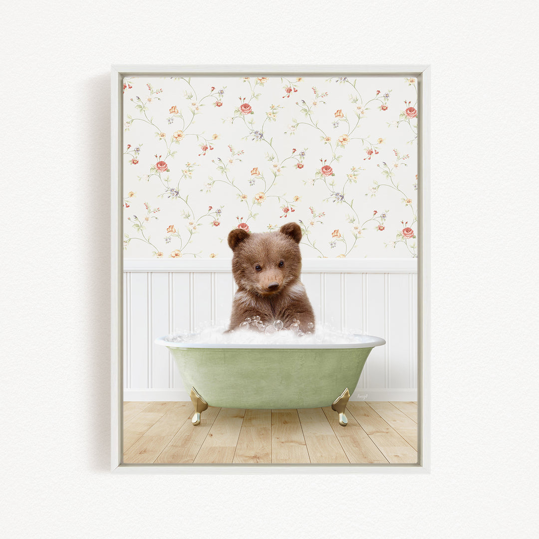 A brown bear sitting in a green bathtub filled with water, with a floral wallpaper in the background.