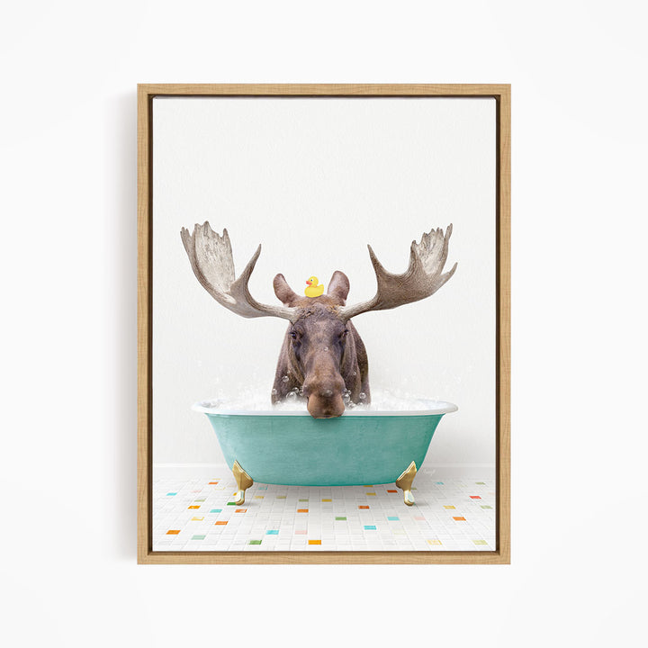 A moose with large antlers is sitting in a blue bathtub, with a rubber duck floating on its head.