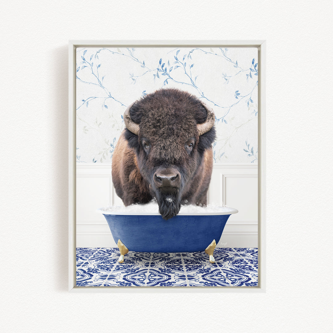 A buffalo with a long beard is sitting in a blue bathtub, looking directly at the camera.