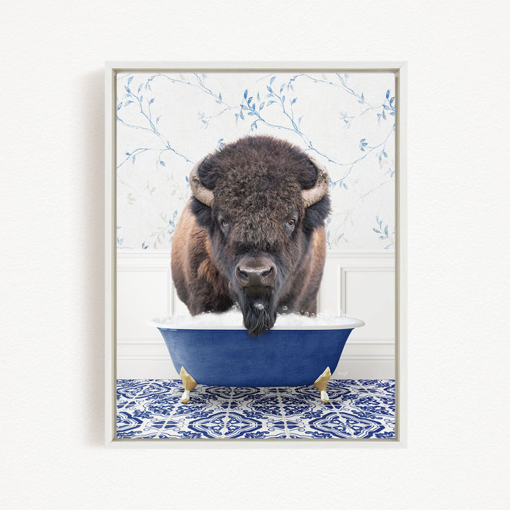 A buffalo with a long beard is sitting in a blue bathtub, looking directly at the camera.