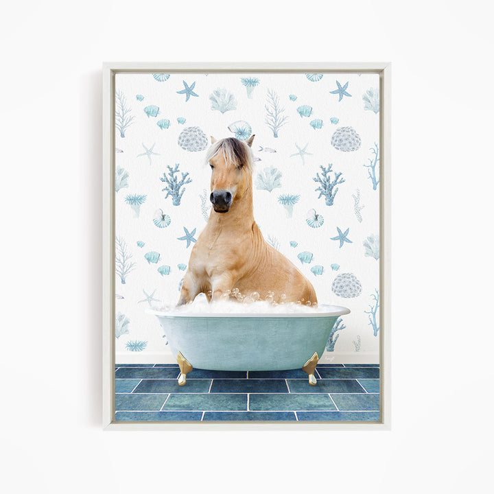 A light brown horse is sitting in a blue bathtub filled with water, surrounded by a pattern of blue and white seashells and starfish.