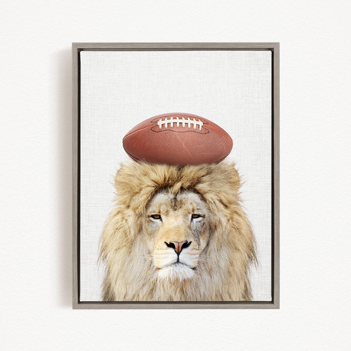 A lion with a football on its head, wearing a serious expression, is the central focus of the image.