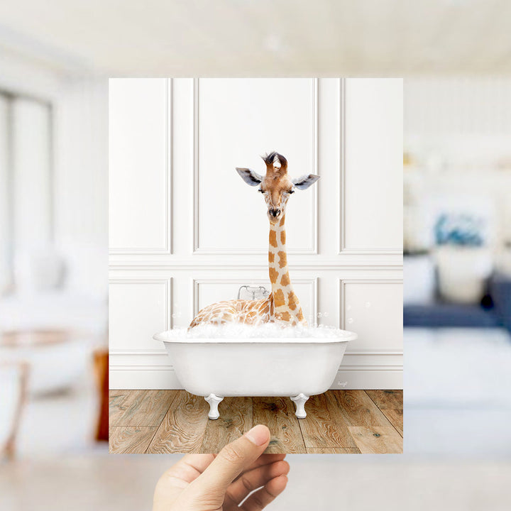 A giraffe sitting in a white bathtub filled with water, surrounded by a blurred background.