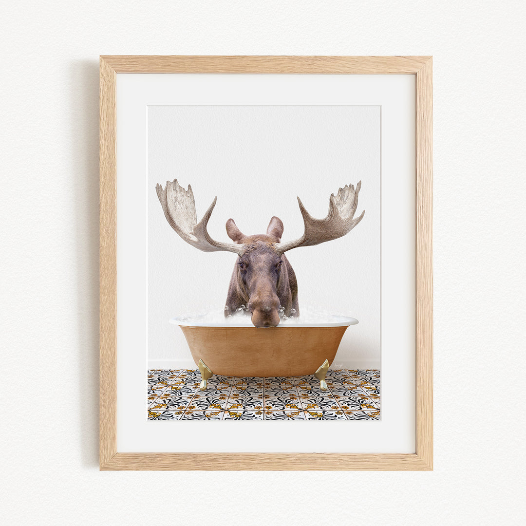 A moose with large antlers is sitting in a bathtub filled with water, creating a whimsical and playful scene.