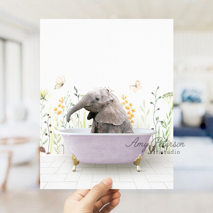 a hand holding up a card with a picture of an elephant in a bathtub