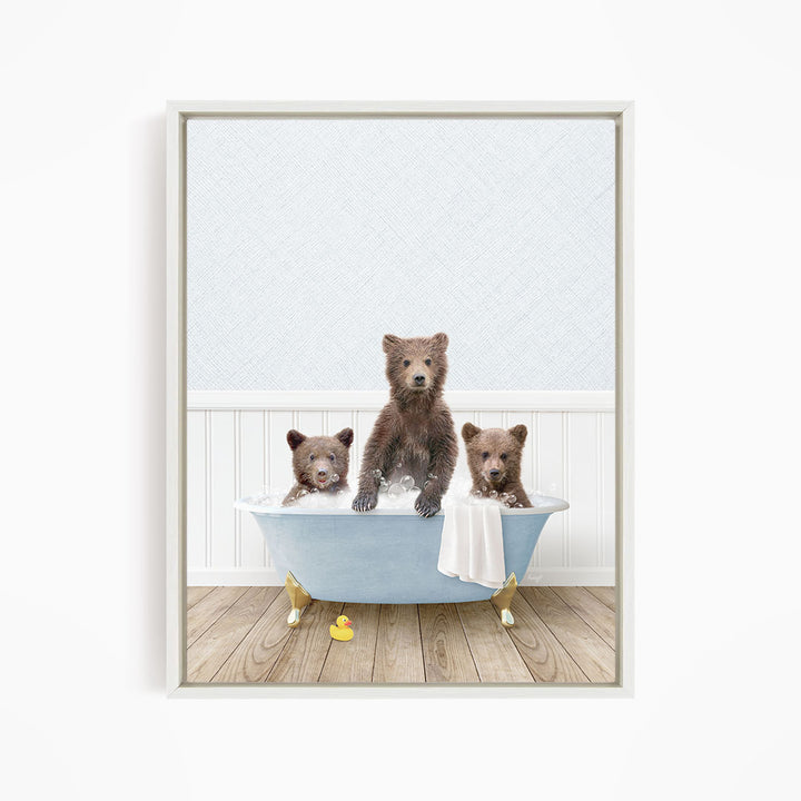 A framed image depicting three brown bears sitting in a blue bathtub, with one bear sitting in the center and two bears sitting on either side.