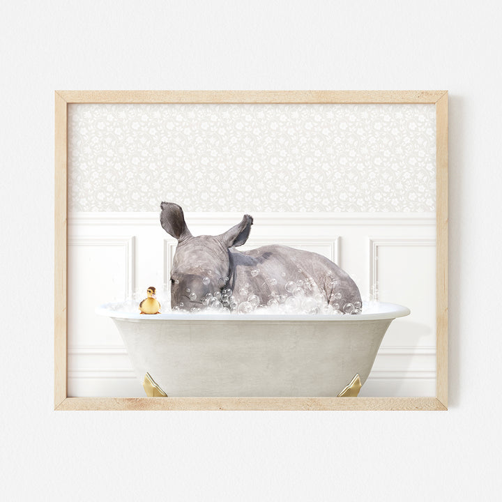 a rhino laying in a bathtub with bubbles