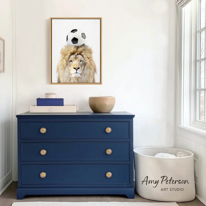 a blue dresser with a framed picture of a lion on top of it, and a white basket next to the dresser.