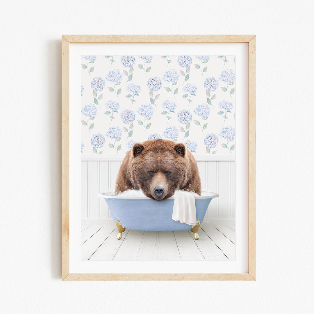 A brown bear is sitting in a blue bathtub, surrounded by a floral patterned wall.